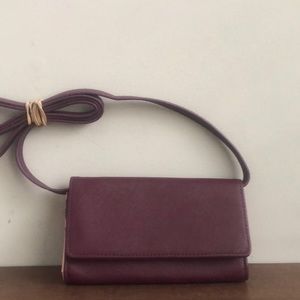 It’s a purple organize /budgeting crossbody wallet